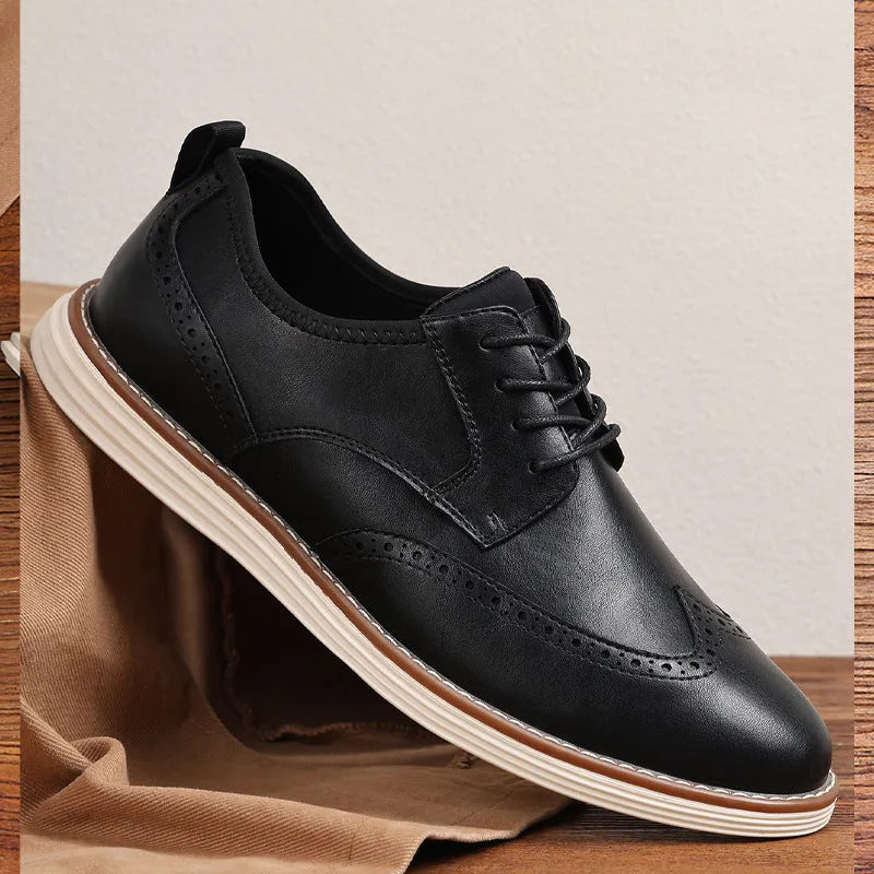 Men's black and brown slip-on business casual shoes with round toe and carved pattern detail