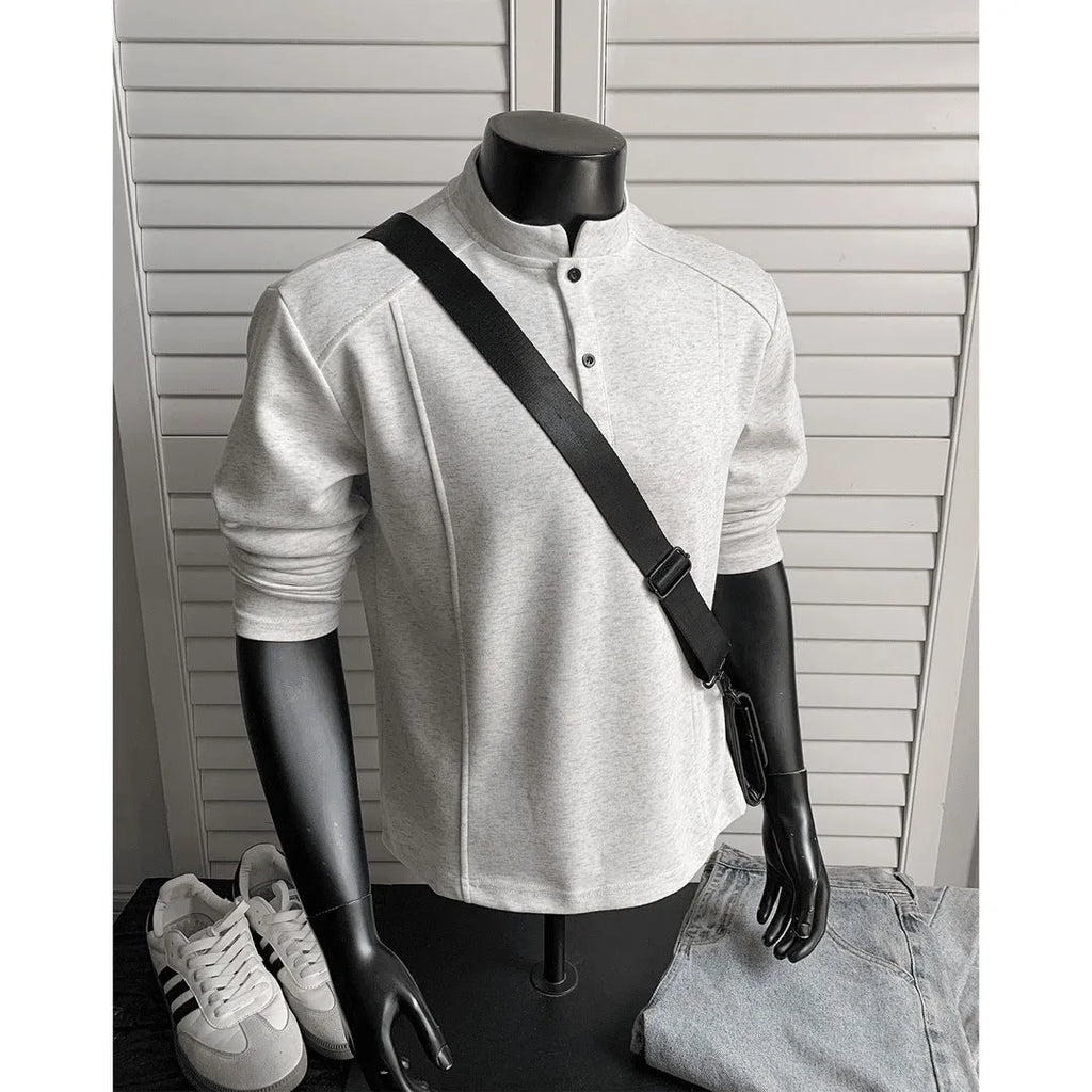 Man wearing a grey patchwork stand-up collar polo shirt with asymmetric shoulder detail
