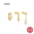 S925 sterling silver geometric earring set with three studs in gold tone on a flat surface.