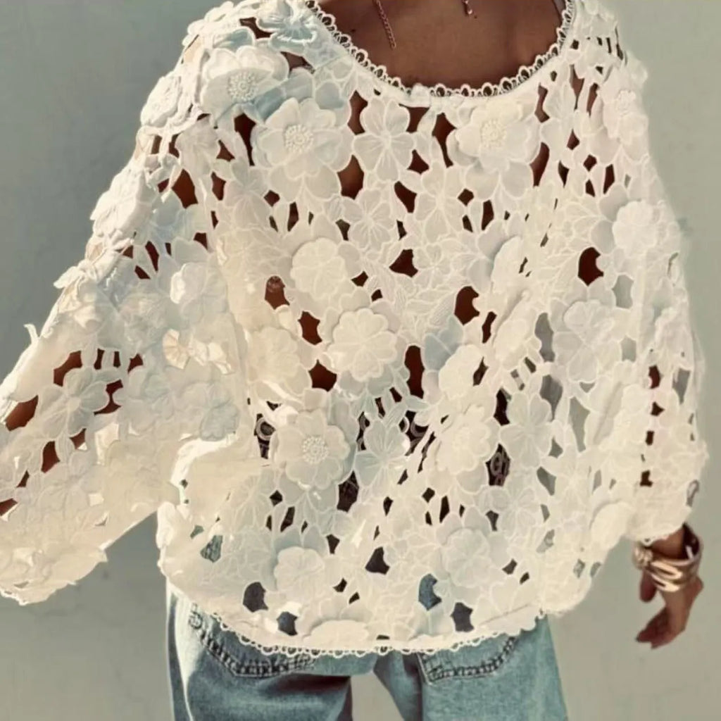 Loose V-neck lace cardigan with white three-dimensional floral decorations on a black background.