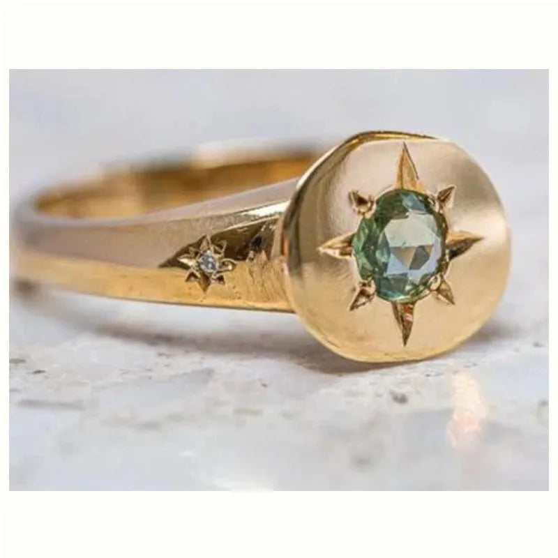 Gold coloured adjustable ring with star-shaped asterism zircon detail and micro inlay treatment