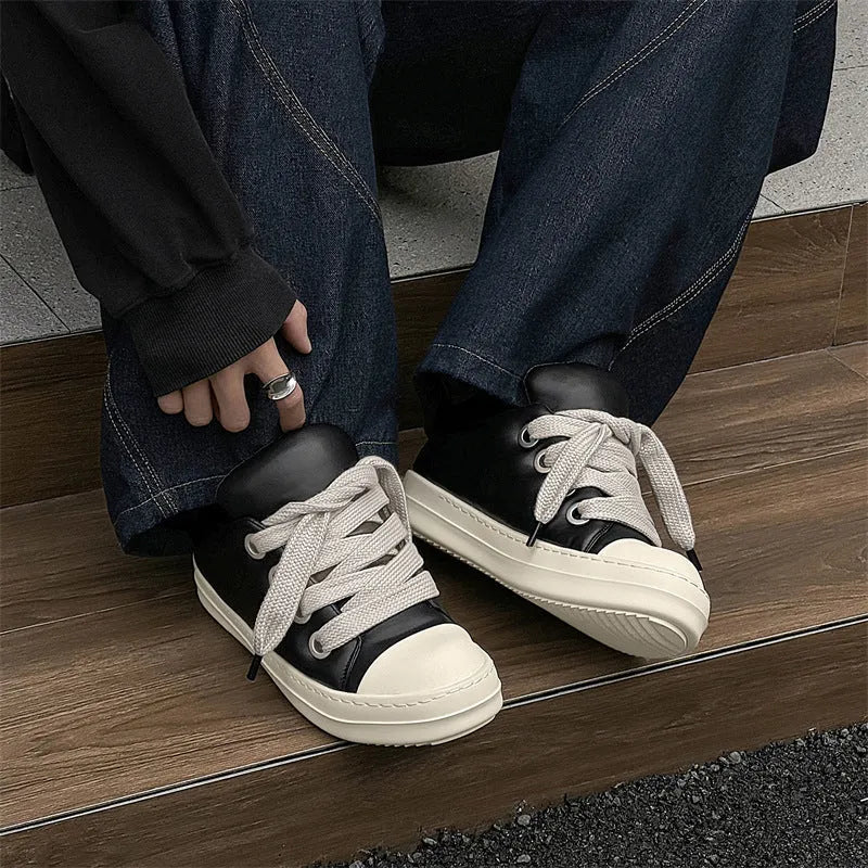 Men's black leather slip-on casual shoes with raised bottom board and round toe, side view