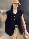 Women's loose-fit sleeveless polyester vest in black with visible pocket detail on the front.