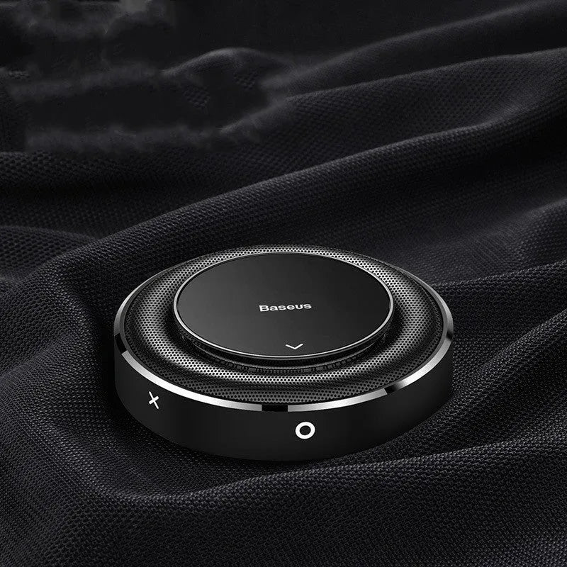 Black aluminium alloy round car fragrance seat with aromatherapy tablets on a car dashboard.