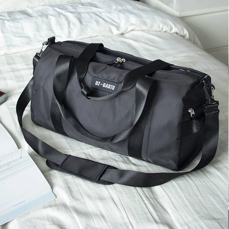 Beige nylon sports bag with contrast colour letter pattern on a white background