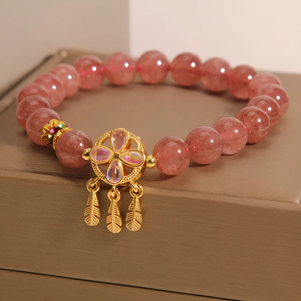 Women's strawberry quartz bracelet with four-leaf clover dream catcher pendant and silver ball charms
