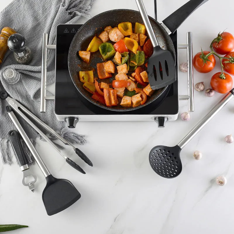 Black silicone kitchen utensil set with stainless steel handles including spatulas and spoons