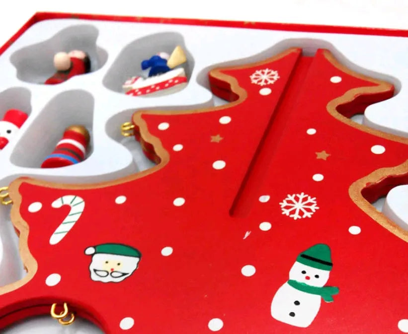 Set of three hand-painted wooden Christmas trees in green and red, 36cm tall, on a table