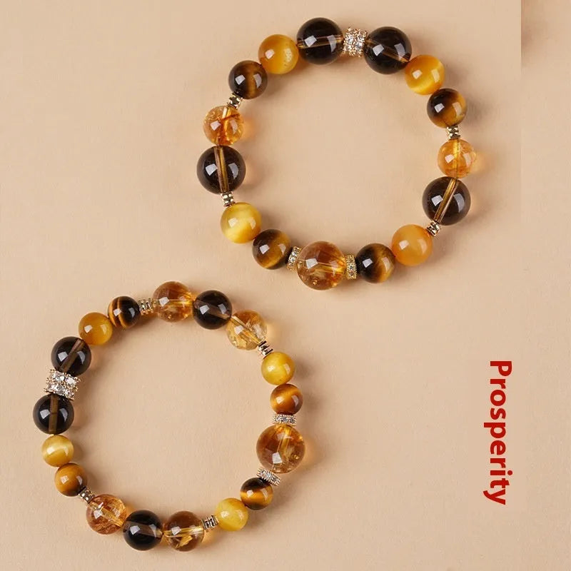 Natural tiger-eye crystal bracelet with geometric beads in either 10mm or 12mm size on a wrist.