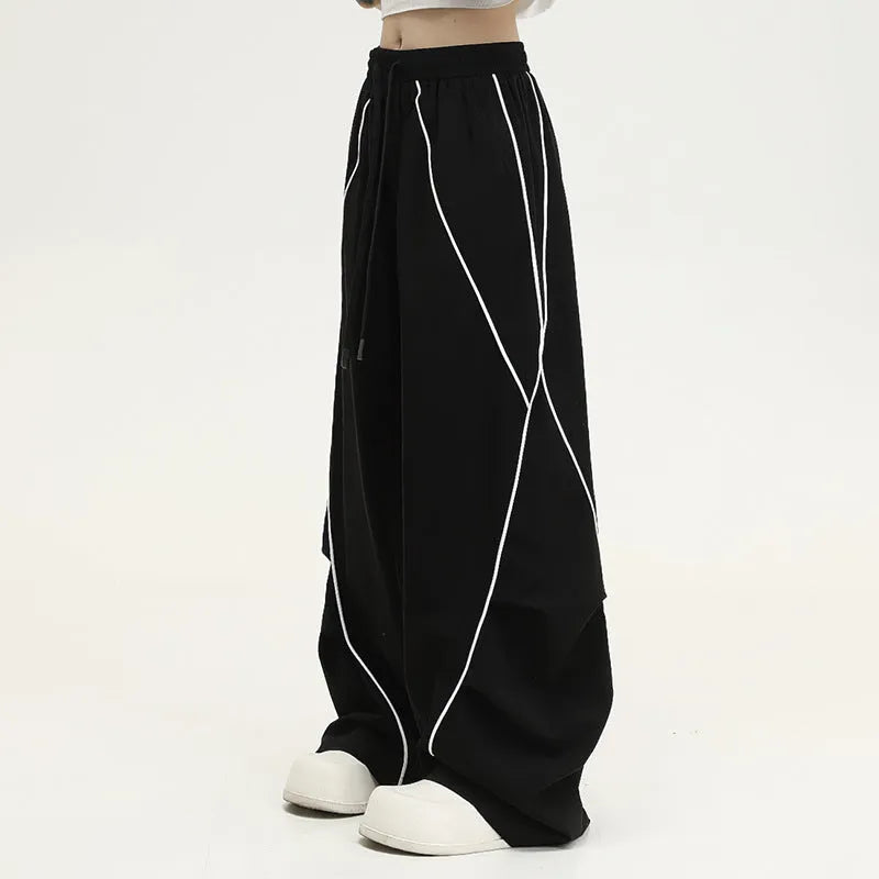 Black pleated wide-leg sports trousers with vertical stripe pattern and mid waist