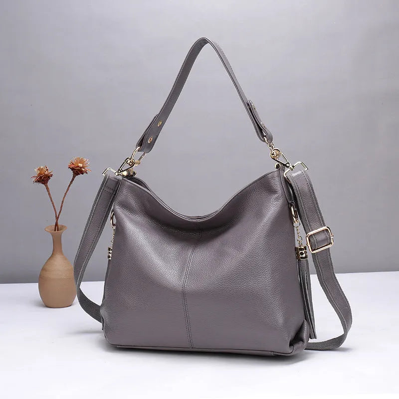 Genuine leather vertical crossbody bag in a square shape with an external sandwich pocket.
