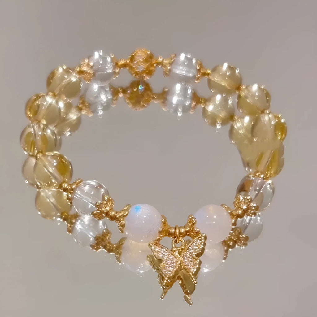 Moonstone white crystal beaded bracelet with citrine butterfly charm on display