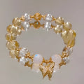 Moonstone white crystal beaded bracelet with citrine butterfly charm on display