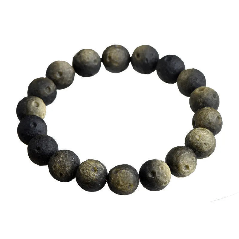 Natural crater ball obsidian bracelet with polished spherical beads showing textured meteorite-style patterns