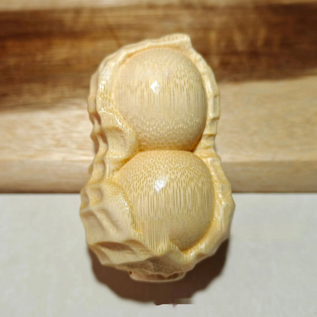 Solid bamboo carved peanut ornament with modern simplicity style and symbolic message.