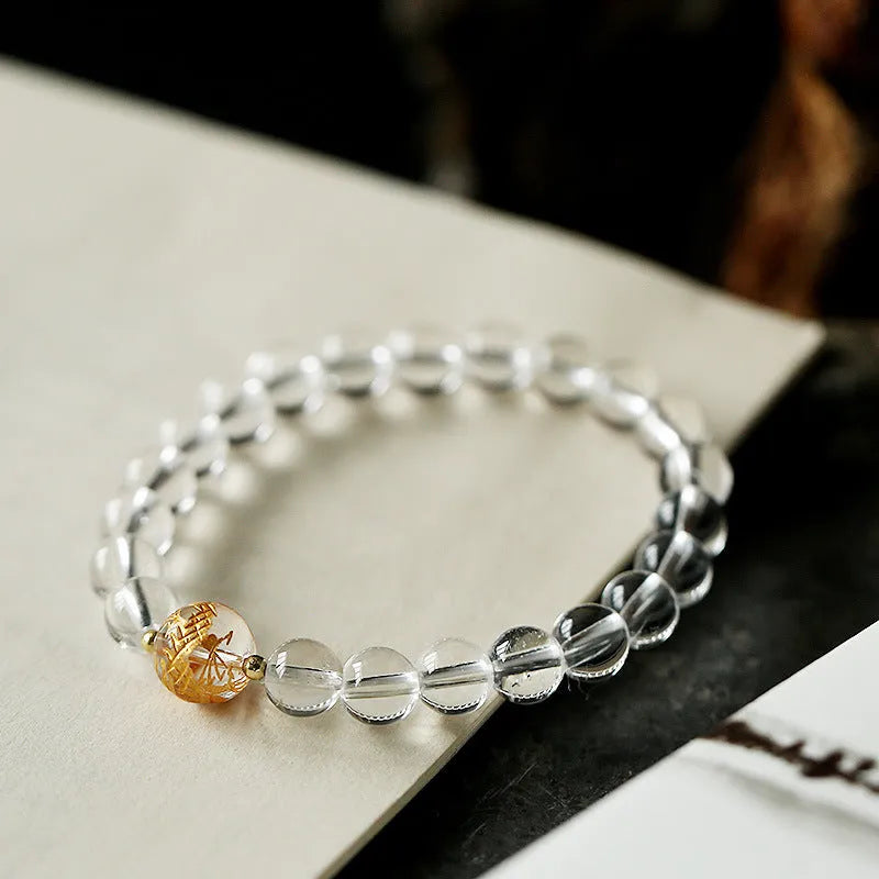 Unisex obsidian black agate white crystal bracelet with 10mm and 8mm beads on neutral background