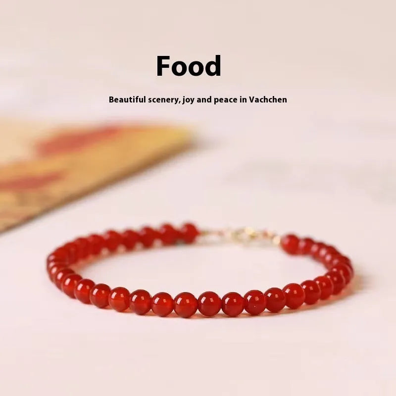 Ultra-thin red agate small bracelet for women, classic style, on a plain background.