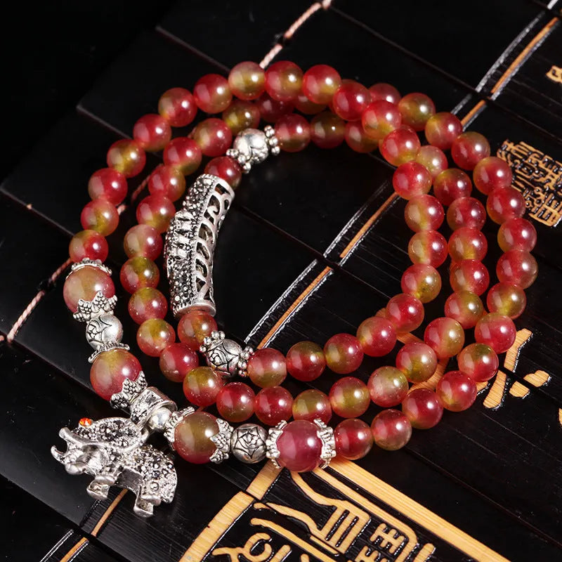 Handmade bracelet with geometric watermelon crystal beads and Chinese knotting in 6mm or 8mm size.