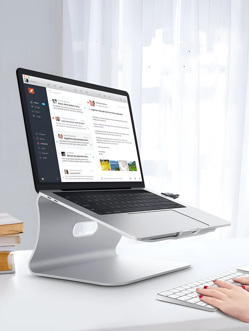 Silver aluminium laptop cooling bracket with striped heat sink on a rotary base.