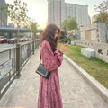 Red floral sweet cover dress with high waist, elastic waist, princess sleeves, and mid-length skirt on a woman