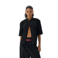 Handmade black loose fit half sleeve hunting shirt with a shirt collar, laid flat.
