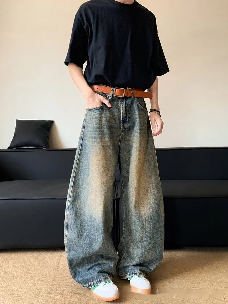 Men's retro blue distressed denim trousers with wide leg cut and vintage wash detailing