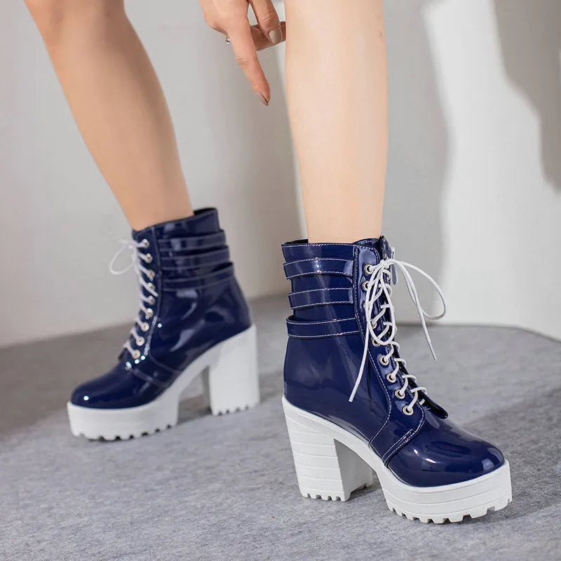 Women's black thick-heeled short boots with lace-up front and round toe, showing waterproof platform detail