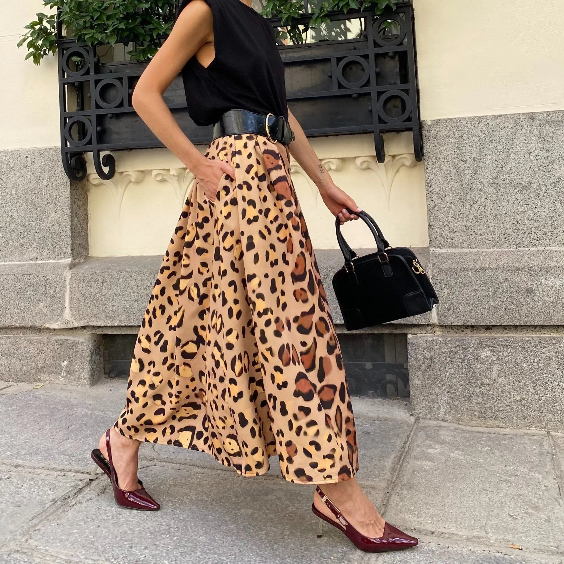 Brown leopard print women's A-line long skirt with a big hem detail on a mannequin.