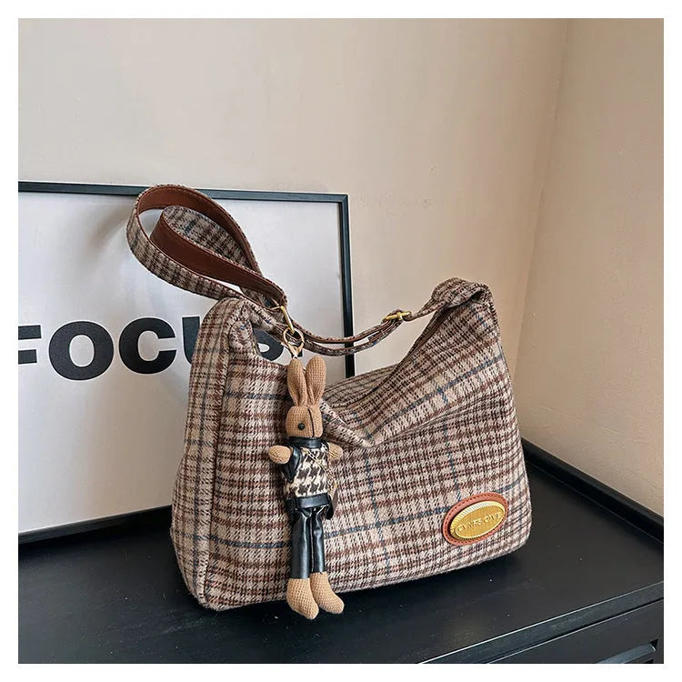 Large capacity soft woolen shoulder bag for women in khaki with pendant, horizontal square shape with sewing line detail.