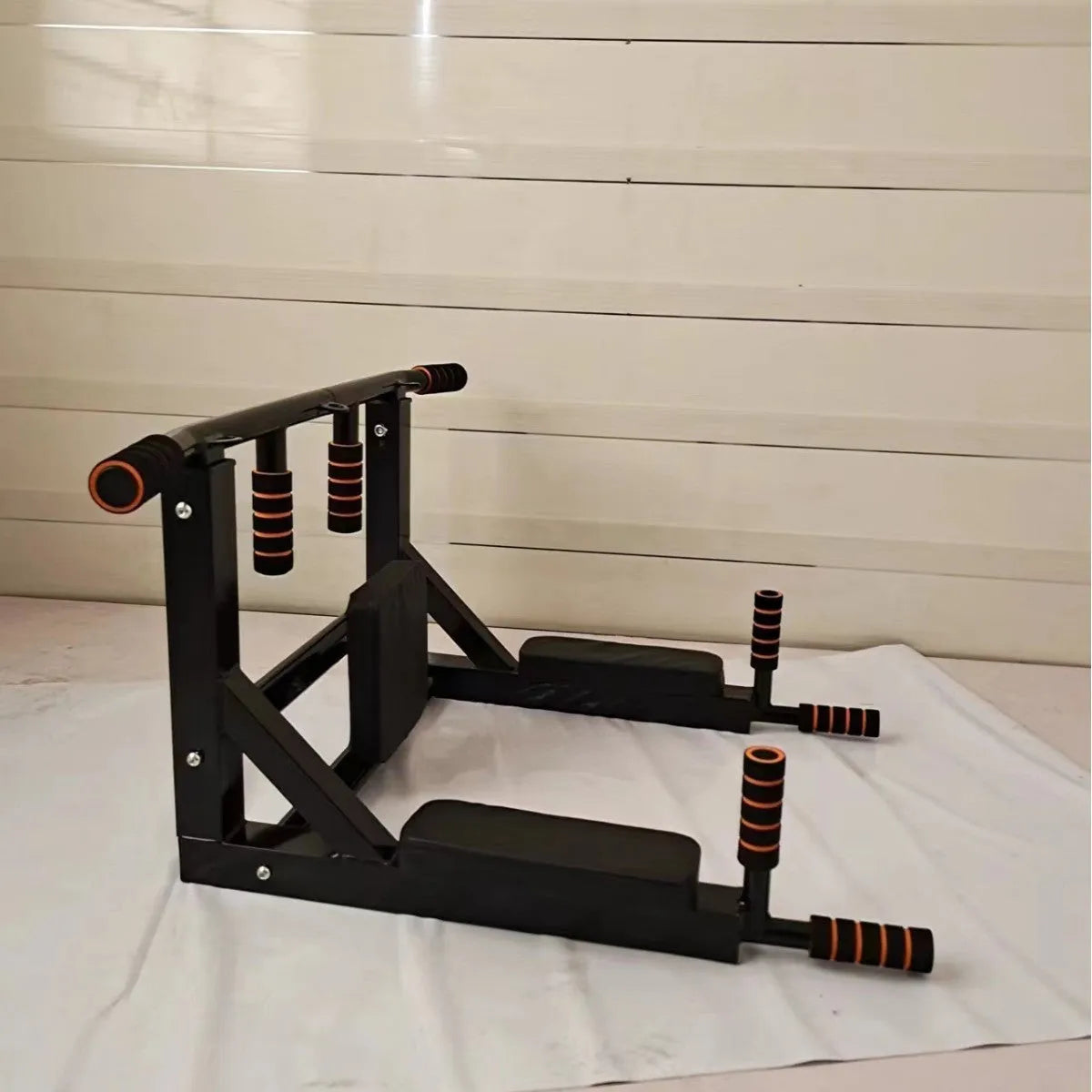 Black wall-mounted steel fitness rack with sandbag holder and single parallel bars for pull-ups