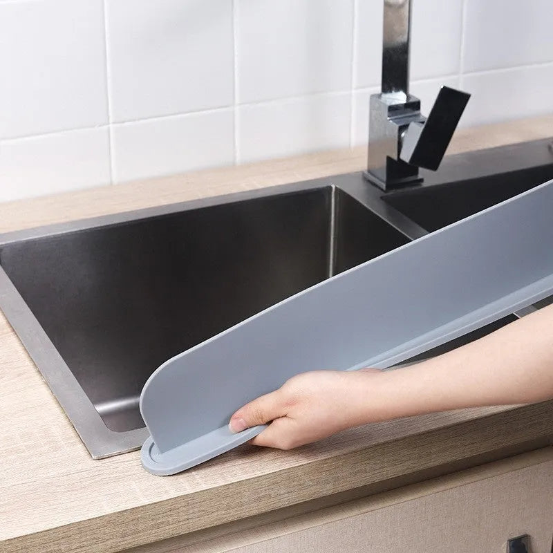 Grey silicone kitchen sink water blocking plate showing dimensions on a countertop.