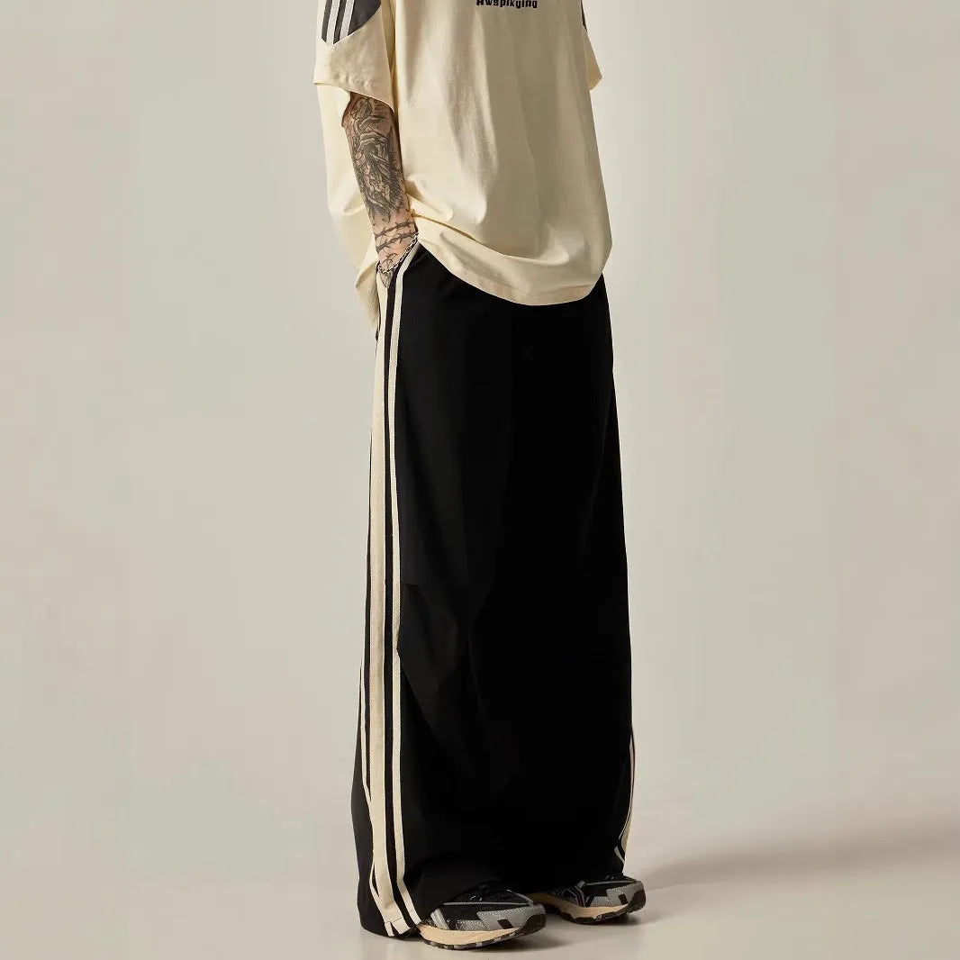 Black men's wide-leg climbing pants with a high waist and long straight-leg design on a neutral background.