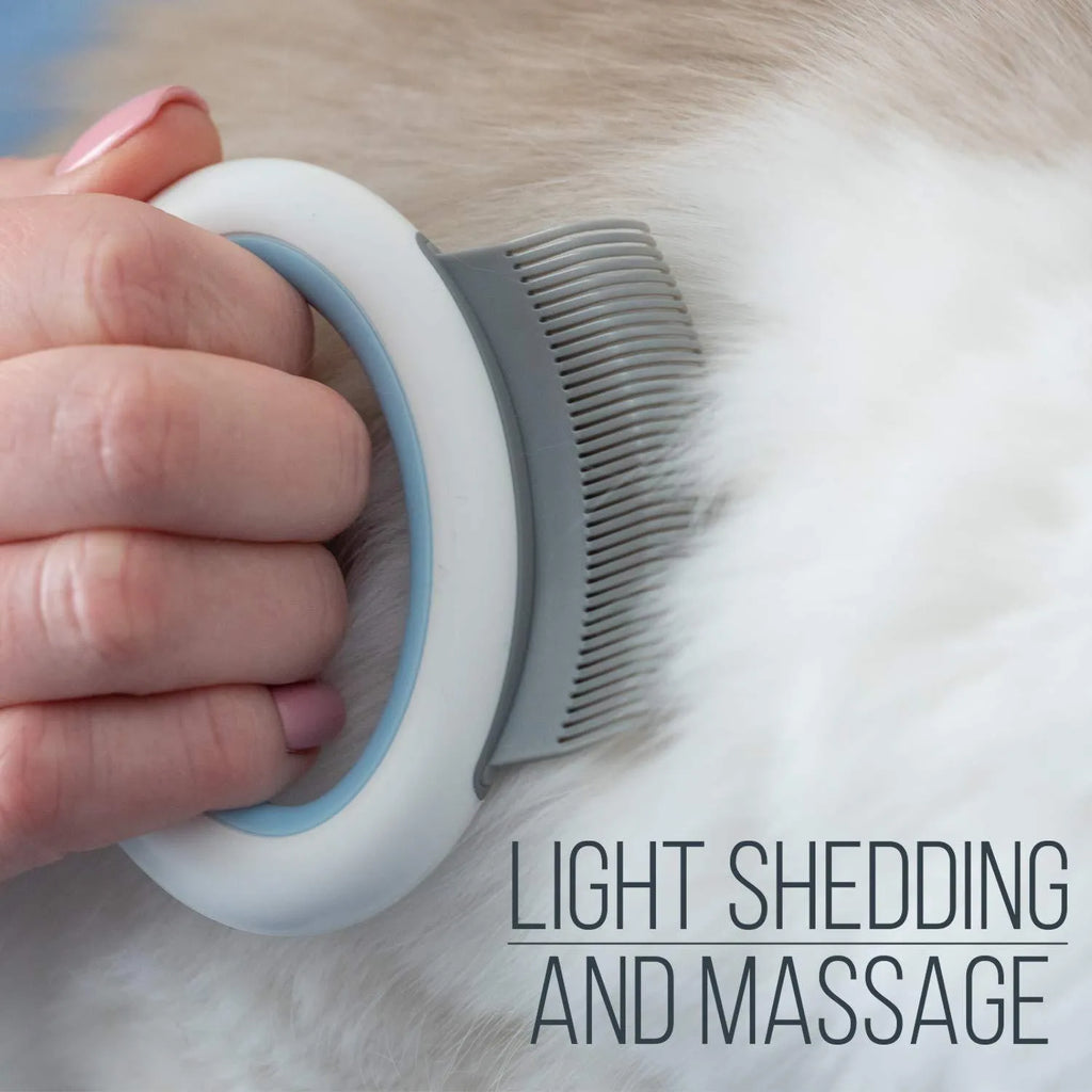 Blue pet deshedding comb with soft plastic teeth and an ergonomic handle on a white background.