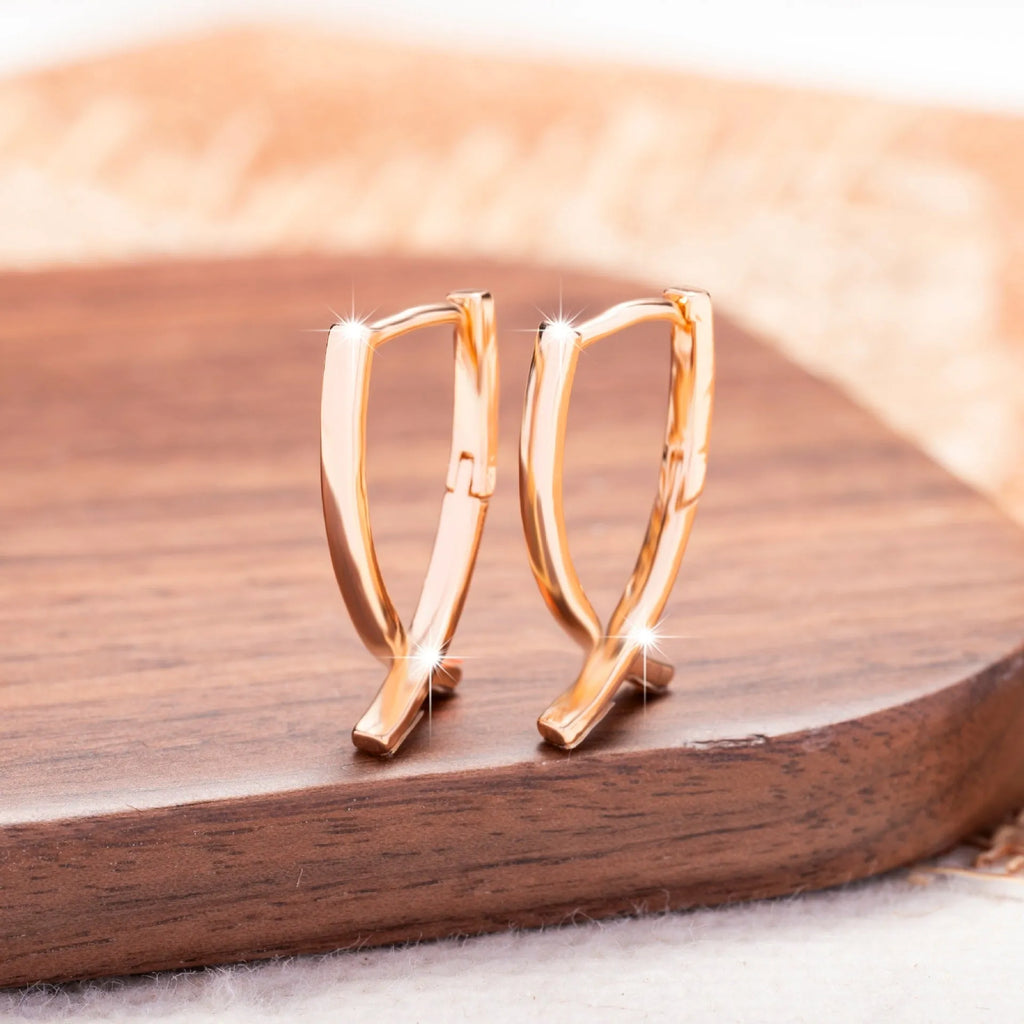 Rose gold copper cross shaped earrings with geometric design for pierced ears