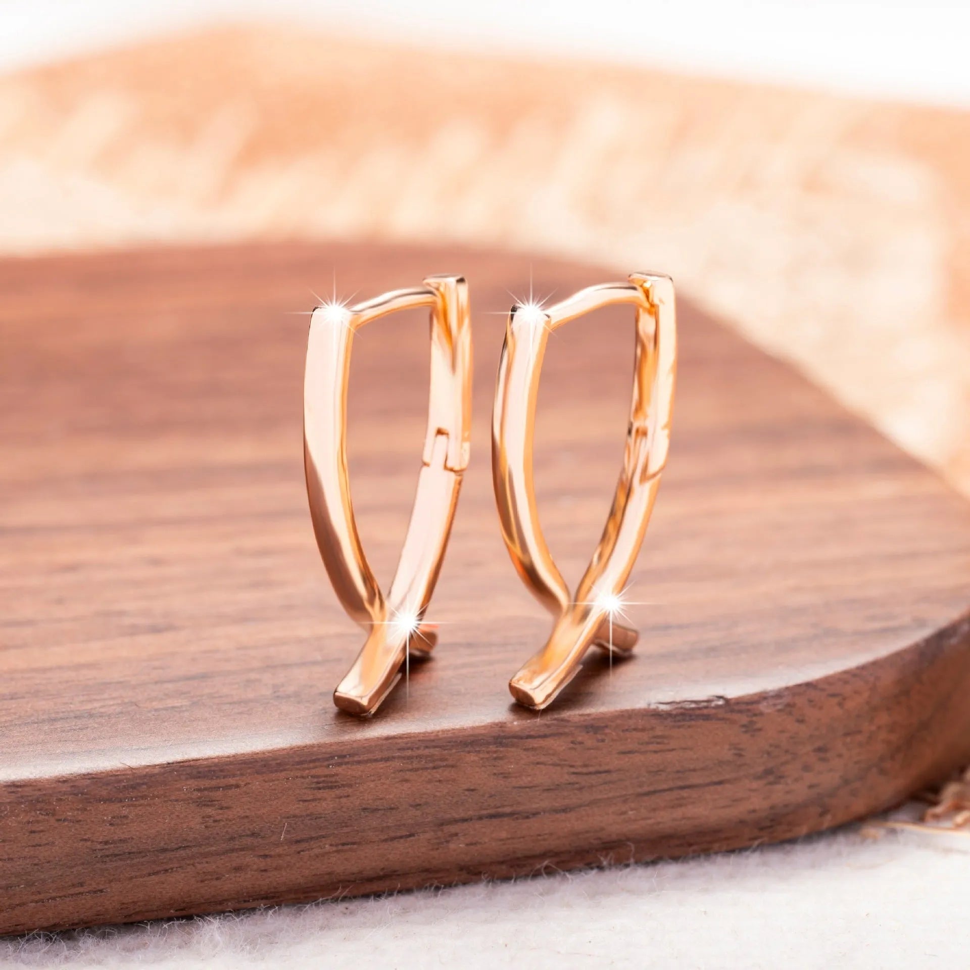 Rose gold copper cross shaped earrings with geometric design for pierced ears