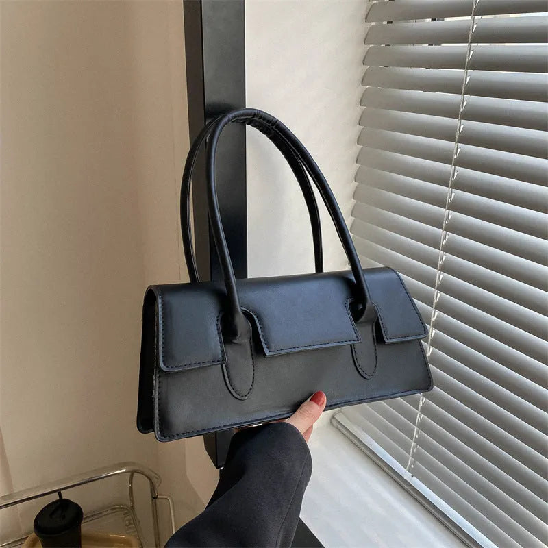 Women's retro style small square PU shoulder bag in black with visible stitching and a single strap