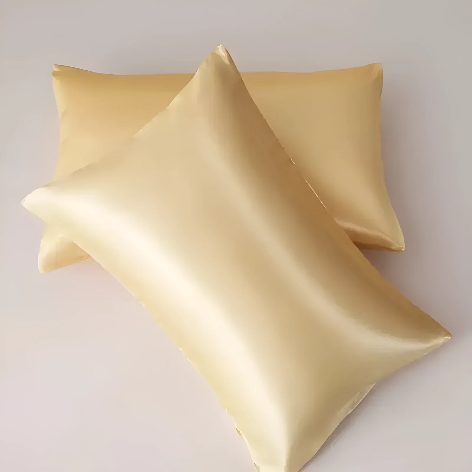 A pair of solid colour satin cloth pillowcases made from polyester fabric, showing one of 13 available colour options.