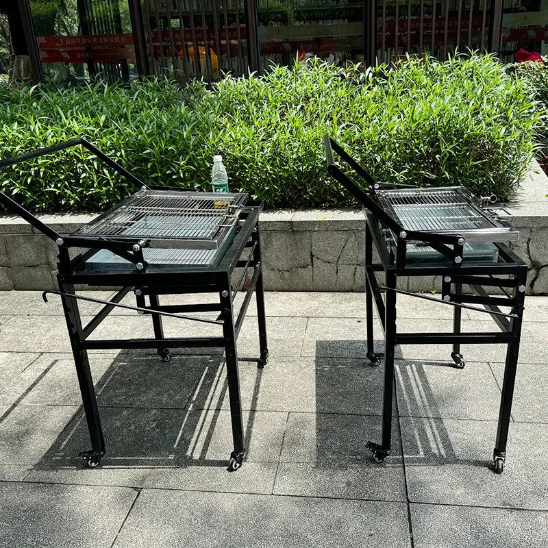 Large foldable Flip BBQ Stove charcoal barbecue grill set up in a garden.