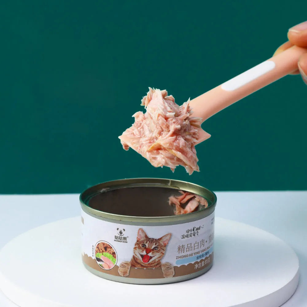 Green long-handled TPR spoon for scooping pet canned food on a white background