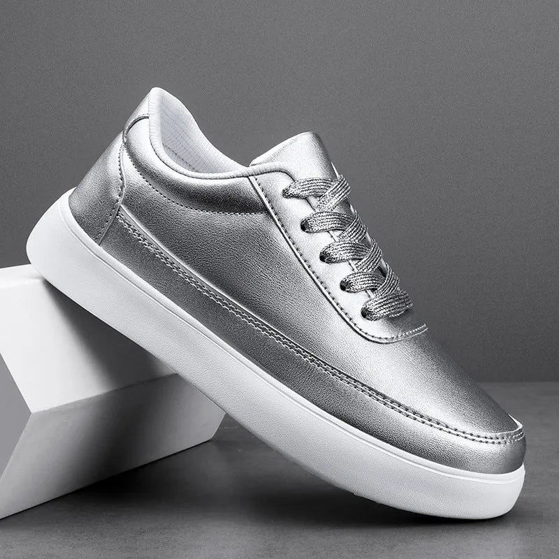 Women's leather flat casual trainers in gold, featuring front lace-up design on a white background.