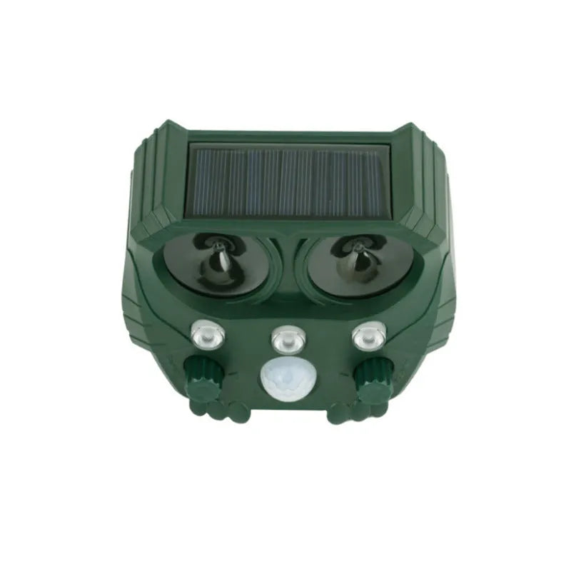 Green solar-powered ultrasonic dog repeller with LED lights for outdoor animal deterrent.