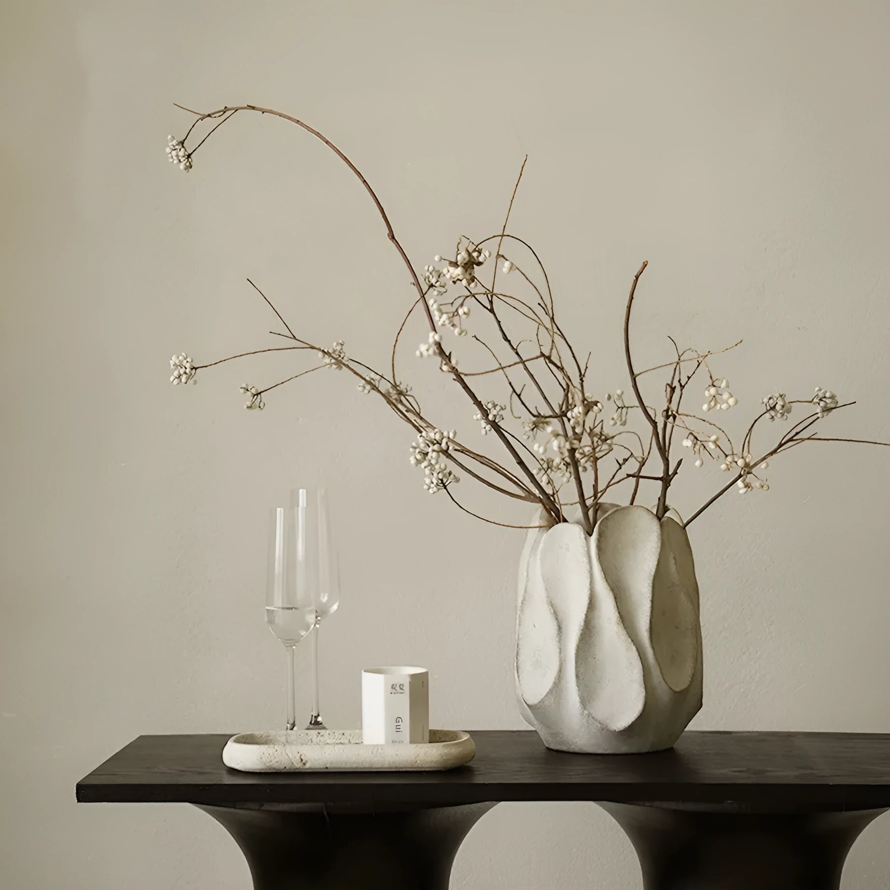 Irregular ceramic vase in magnesium clay for flower arrangements on wooden surface