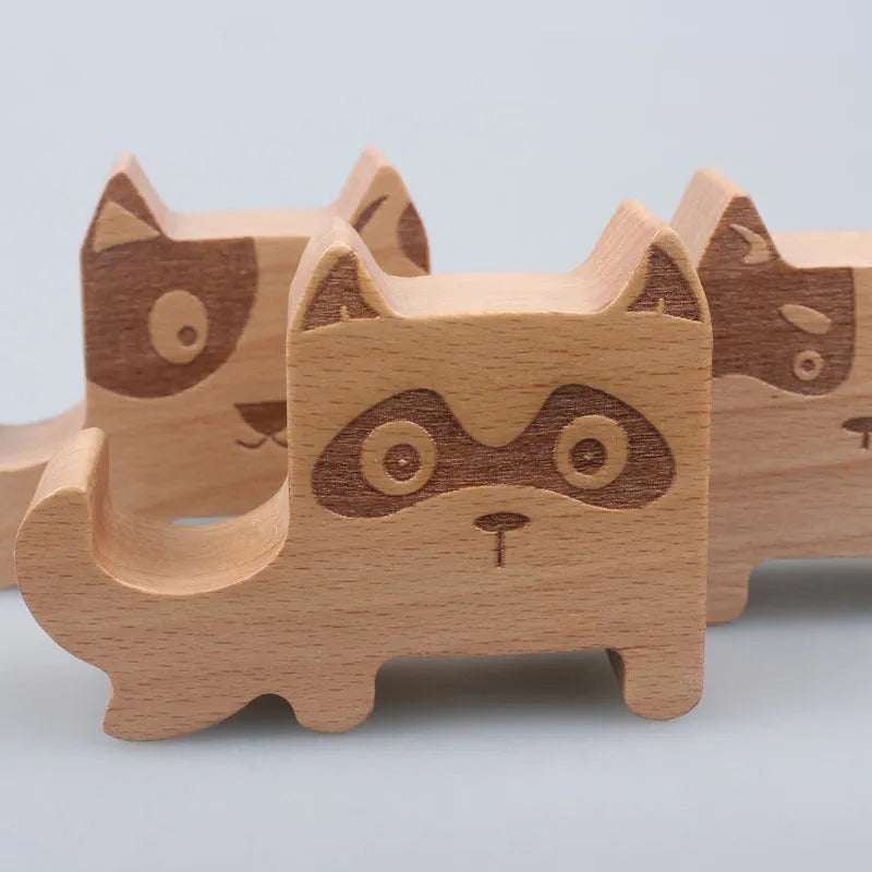 Beech wood mobile phone holder with resin animal design and coin slot