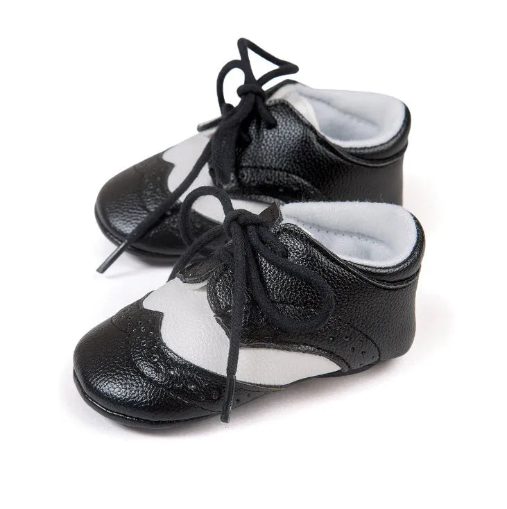 Vintage style soft-soled baby walking shoes in synthetic leather, shown in light brown colour.