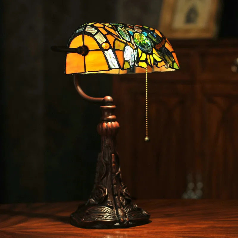 Tiffany table lamp with stained glass shade on resin base, 25cm wide by 36cm tall