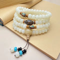 White Jade Bodhi 108 bead bracelet showing detail of spherical beads on a wrist.