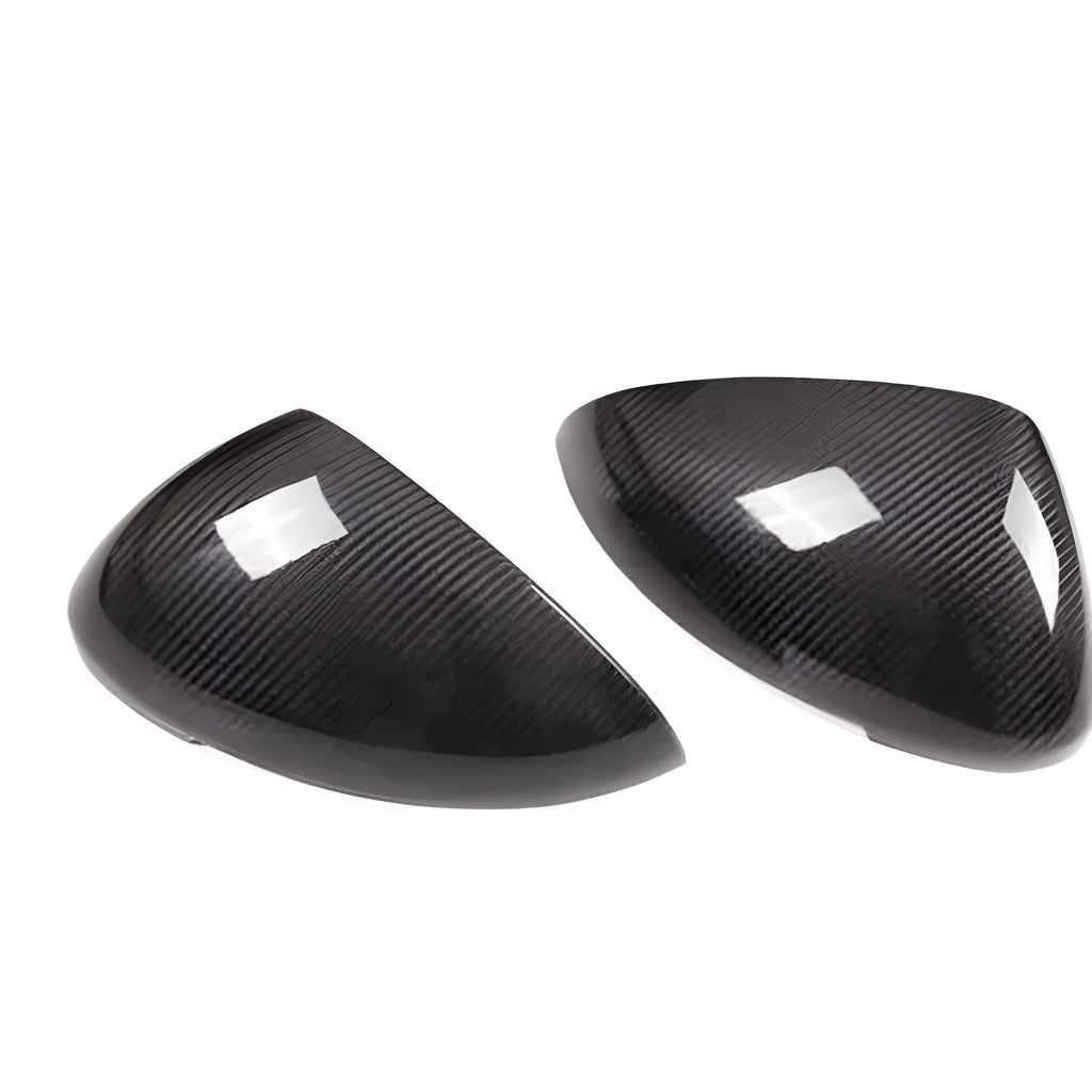 Pair of black true carbon fibre rearview mirror covers for Porsche Macan on a white background.