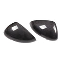 Pair of black true carbon fibre rearview mirror covers for Porsche Macan on a white background.