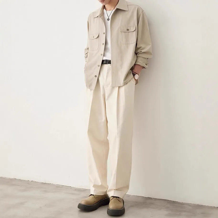Men's light sand rice coloured cotton shirt with lapel collar and long sleeves laid flat.