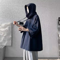 Men's loose fit hooded short sleeve t-shirt in solid colours on a grey background.